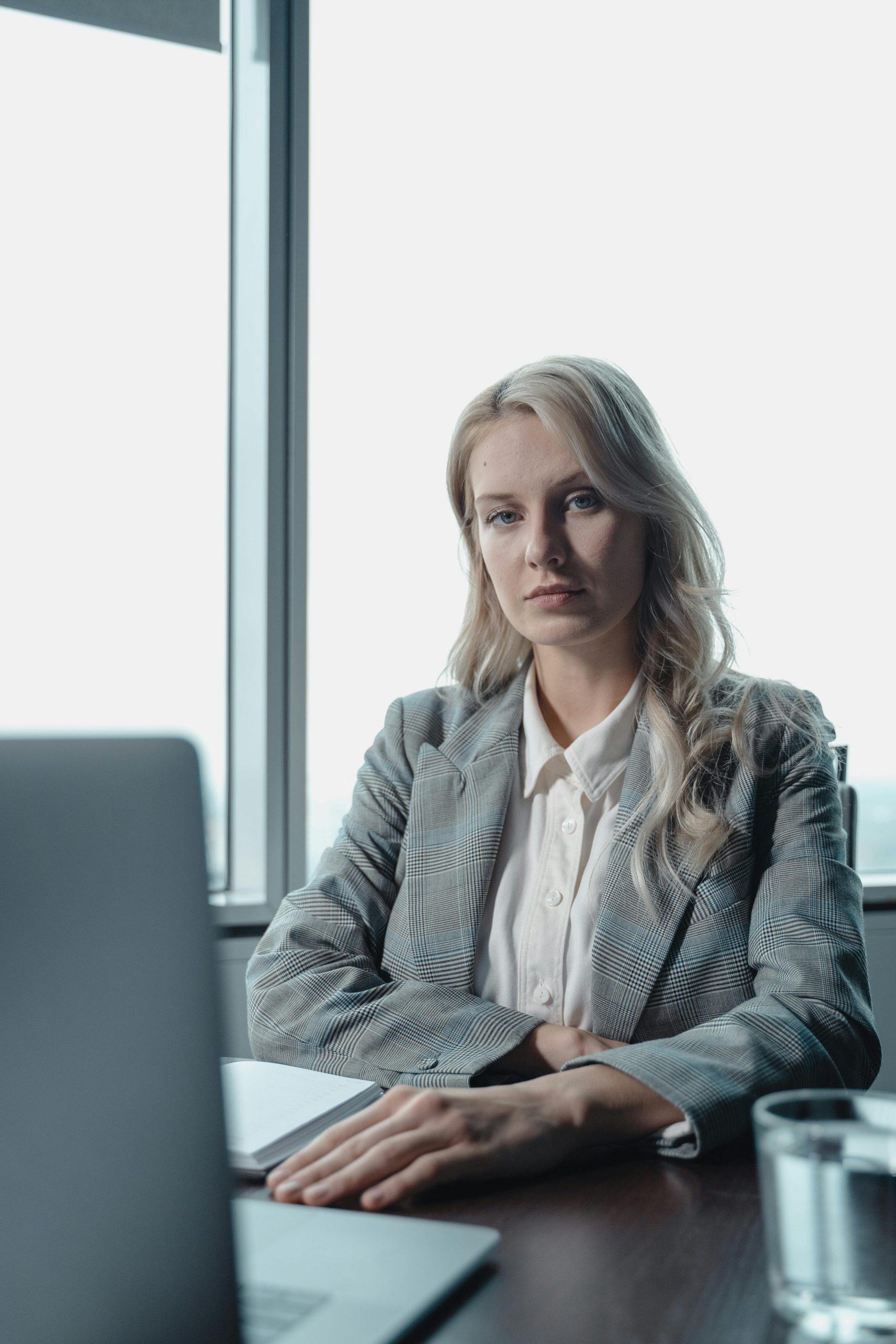 Confident businesswoman at desk in a modern office setting.